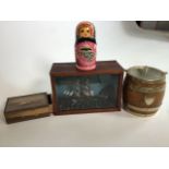 Small ship in display case, biscuit barrel and a Tunbridge ware style box and Russian dolls.