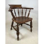 Elm smoker’s bow chair, with baluster turned supports and fine grain interest to seat pad and the