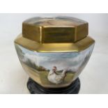 A hand painted and gilded bone china lidded jar painted by Ex:Royal Worcester artist James