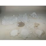 A collection of vintage lace items including two camisole tops , a lace trimmed bonnet, ann apron