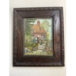 An early 20th century oil on canvas of a country cottage in a period oak frame.W:38cm x H:44cm