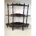 A 19th century mahogany three tier whatnot with shaped shelves, turned supports and legs. W: