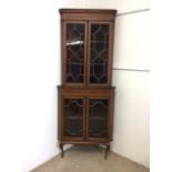 An inlaid Edwardian two piece corner cupboard each section with double doors to shelvesW:70cm x