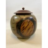 A decorative rounded bowl with wooden lid, resin bowl with paint effect.