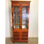 A reproduction glazed two piece mirrored China cabinet with three glass shelves. Lower section three