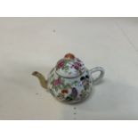 A small Famille Rose Chinese porcelain tea pot circa 1860-1880. Restoration to the spout H:7.5cm