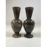 A pair of marble vases of circular form.H:22cm W:7cm x D:7cm.