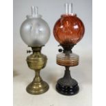 Two oil lamps. Crack to glass on amber shade.