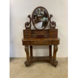A Queen Anne style dressing table with bevelled swing mirror with vanity drawers on large castors.