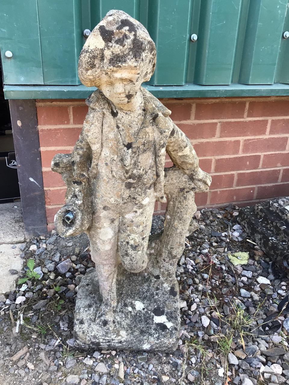 A reconstituted stone statue water feature of a young man. Piped for water. W:40cm x D:24cm x H: