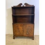 An inlaid small bookcase with cupboard below. W:62cm x D:27cm x H:108cm