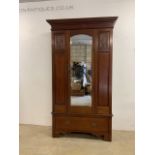 An art Nouveau mirrored wardrobe with bevelled mirror, large drawer to base. W:106cm x D:51cm x H: