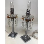 A pair of chrome Corinthian column amber and clear lustre table lamps W:10cm x H:40cm height to