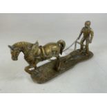 Brass horse and ploughman figure, with chain link reigns. Horse loose to front leg, secured to rear.