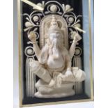 A carved Ganesha, elephant headed Hindu god. A carved sculpture in light wood in box frame. W:20cm x