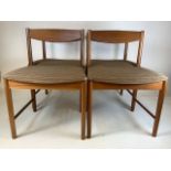 A set of four mid century teak dining chairs of wide proportions