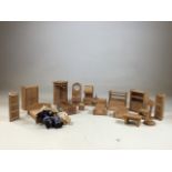 A collection of wooden dolls house furniture with three dolls