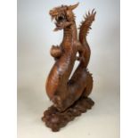 A very large carved dragon from one piece of wood. W:65cm x D:35cm x H:106cm