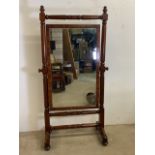 A very large regency mahogany cheval mirror with original Copes patent brass castors and original