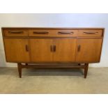 A mid century E Gomme G Plan teaksideboard with three drawers above cupboards. W:152cm x D:46cm x