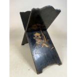 An early 20th century oriental black lacquered book rest. W:60cm x D:26cm x H:49cm