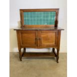 A small early 20th century marble topped wash cupboard with period tiles. Marble with fossilised