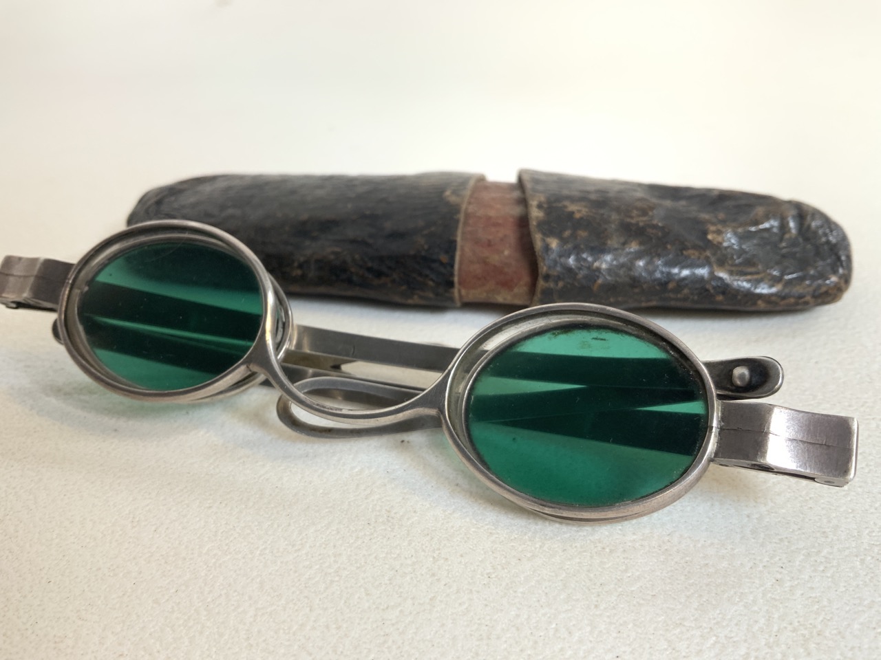 A pair of white metal framed oval lens sunglasses with green and clear glass lenses. - Image 3 of 4