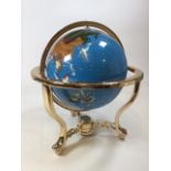 A large Gemstone rotating globe on a brass stand with built in compass to base W:40cm x H:48cm