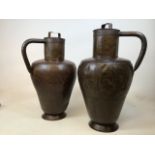 A large pair of copper urns with lids. Slight dents to body of urns W:46cm x H:72cm includes lid and