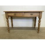 A victorian pine table with two drawers and turned legs. W:120cm x D:57cm x H:74cm