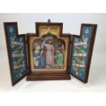A boxed religious triptych in oak case with hand painted doors W:33cm x D:9cm x H:41cm closed 60cm