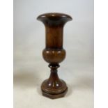 A large turned urn shaped wooden vase on octagonal base. W:22cm x D:22cm x H:50cm