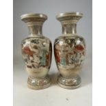 A pair of large decorative Japanese satsuma vases with hand painted images of Japanese life. With