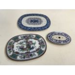 Three 19th century meat drainers/mazarines A blue and white transfer print with ceramic feet, a