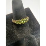9 ct gold green peridot ring, with five stones.