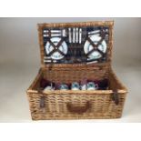 A vintage hamper with a picnic rug and mid century china including Midwinter And Susie Cooper (a/f)