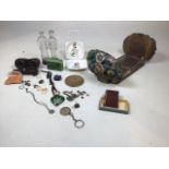 A collection of vintage items including a cased pair of opera glasses, a 1930s book slide, a Poole