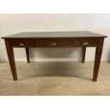 An early 20th century large oak leather topped desk with three deep drawers with brass handles. W: