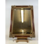 A Large modern decorative mirror with gilt metal decoration and a bevelled edge. W:80cm x H:110cm