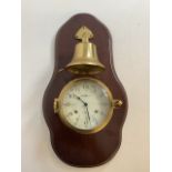 A Howard Miller 11 jewels brass clock and brass stricking bell on mahogany mount. Model No 613-