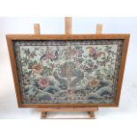 Silk printed book binding in glass frame. Decorated with a colourful Oriental scene. W:36.5cm x D:
