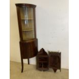 A Corner cupboard with curved glass front, interior with lined shelves and back. Double doors to