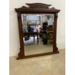 A Large early 20th Century mahogany overmantle mirror with eep bevelled edge and carved details. W: