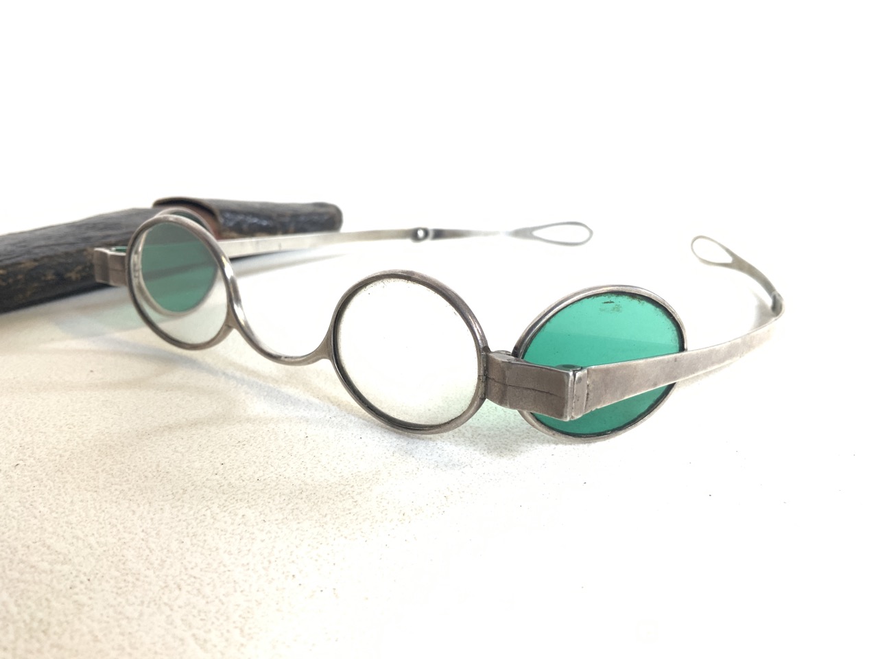 A pair of white metal framed oval lens sunglasses with green and clear glass lenses. - Image 2 of 4