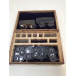 A vintage cased set of optical lenses together with two pairs of cased gold coloured rimmed