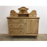 A Victorian pine chiffonier later glass handles, three drawers alongside cupboard with decorative