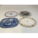 Four 19th century meat drainers/ mazarines A blue and white transfer print, no mark. An Oval