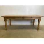 A large pine farmhouse table. W:90cm x D:198cm x H:78cm