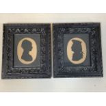 A pair of Georgian silhouettes in carved oak frames. F.W. HAMLIN 1820 QUIET ST BATH handwritten on