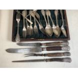 A silver handled carving set also with a plated canteen of cutlery.